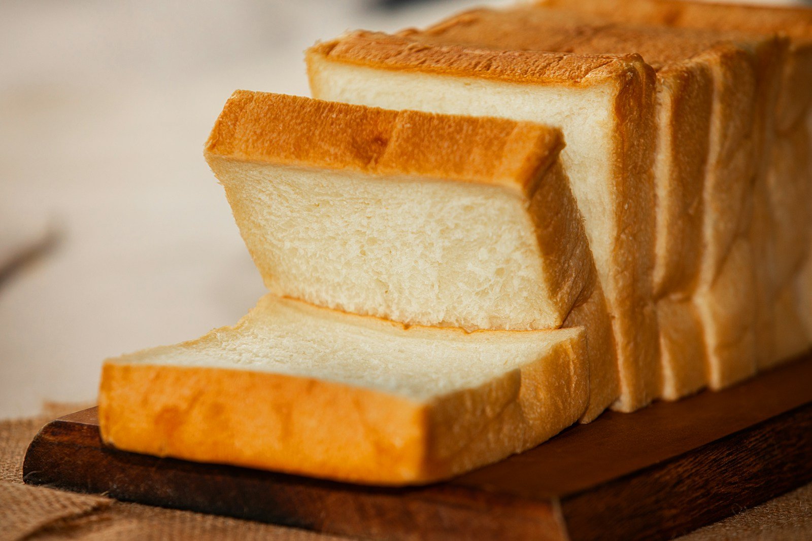 Tranches de pain de mie empilées sur une planche